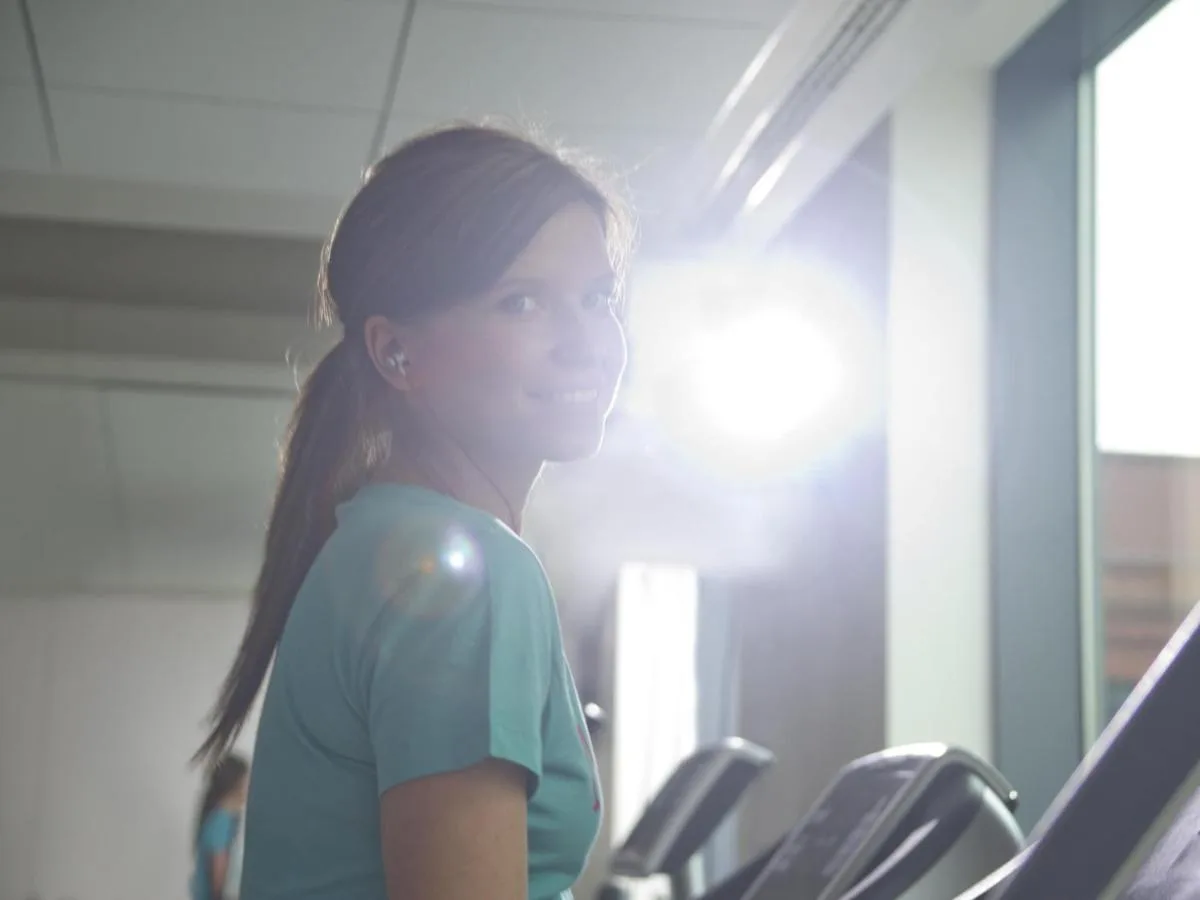 a young girl is running on treadmills in a gym at Novotel Glasgow Centre in Glasgow