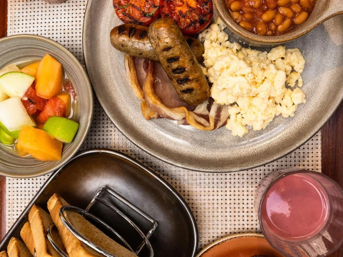 a table topped with two plates of food with different foods at Novotel Glasgow Centre in Glasgow